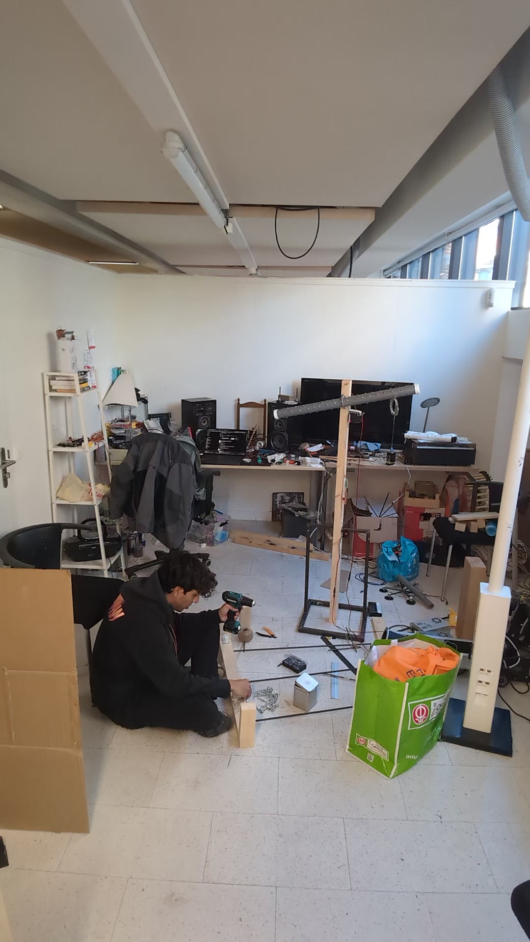 Studio, wide shot (2): same floor, different moment.